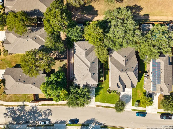 an aerial view of a residential apartment building with swimming pool and lawn chairs