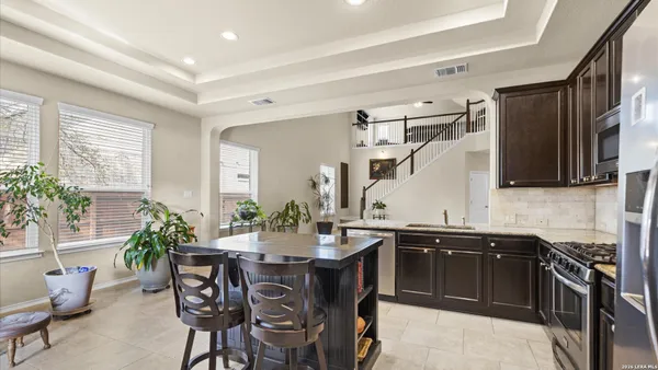 a kitchen with a table and chairs in it