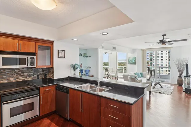 a kitchen with stainless steel appliances granite countertop a refrigerator and a stove