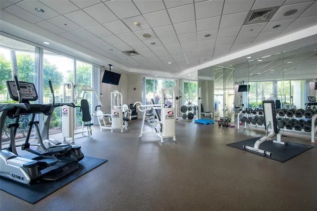 an aerial view of a city with lots of residential buildings ocean and mountain view in back