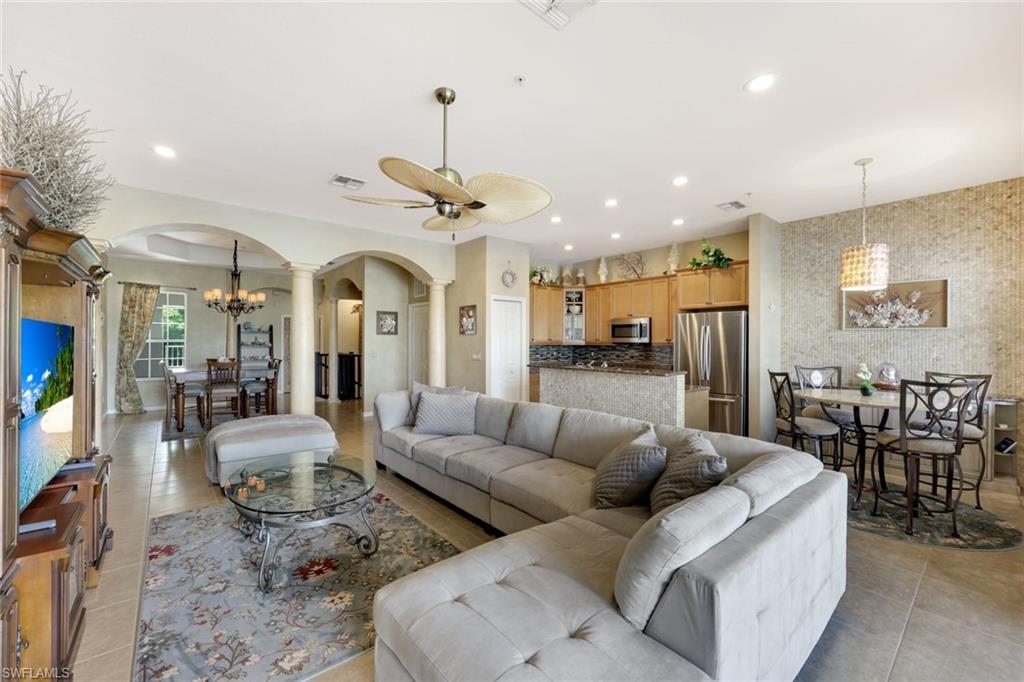 3530 Lansing Loop, Unit 202 Estero, FL 33928 - Photo 20 of 35 a living room with furniture kitchen view and a chandelier