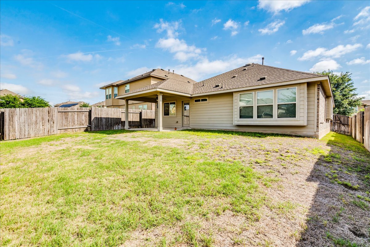 124 Compass Lane Kyle, TX 78640 - Photo 33 of 38 a front view of a house with a yard