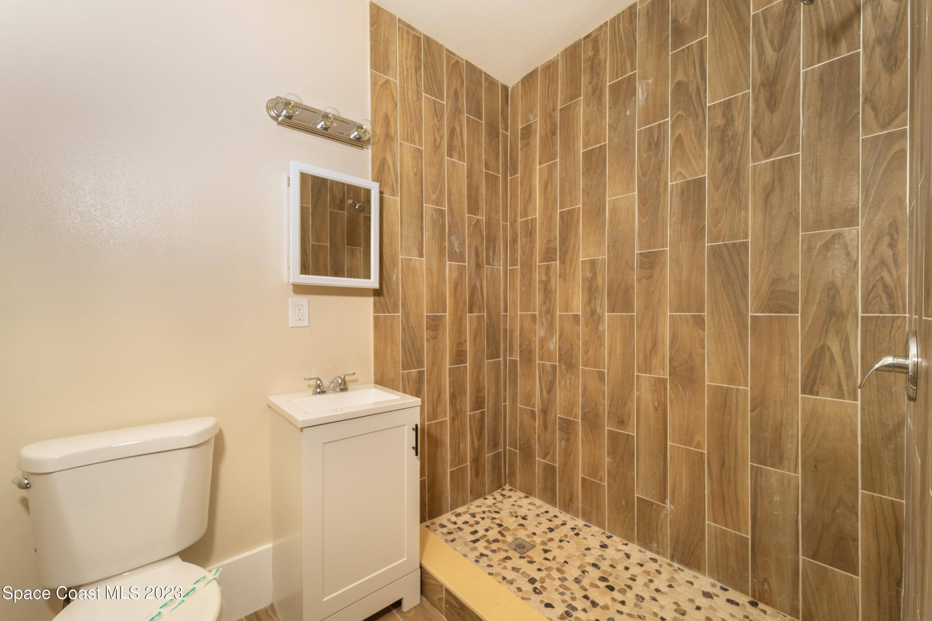 254 Lime Street Cocoa, FL 32926 - Photo 15 of 16 a bathroom with a sink a toilet and shower