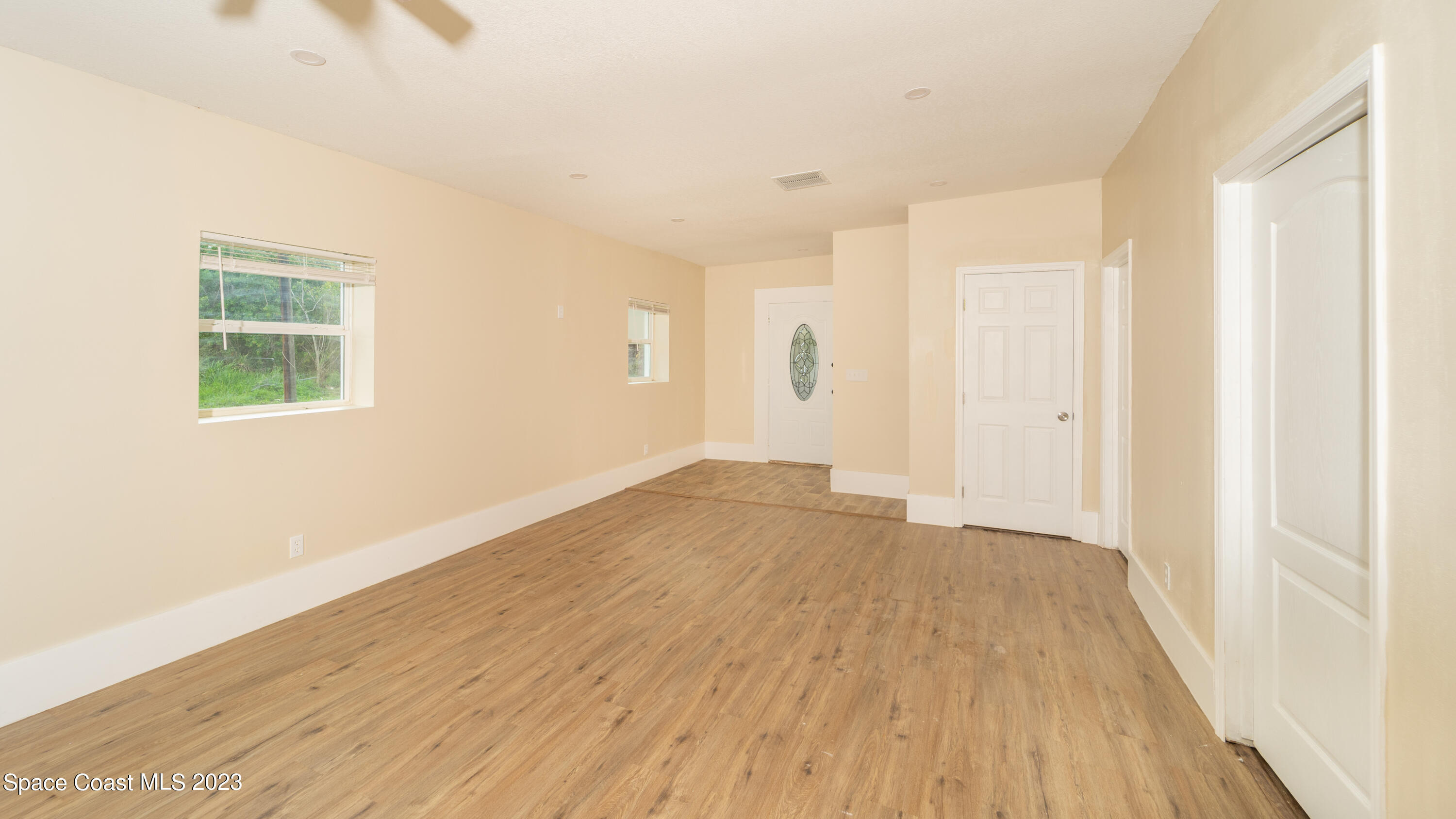 254 Lime Street Cocoa, FL 32926 - Photo 6 of 16 an empty room with wooden floor and windows