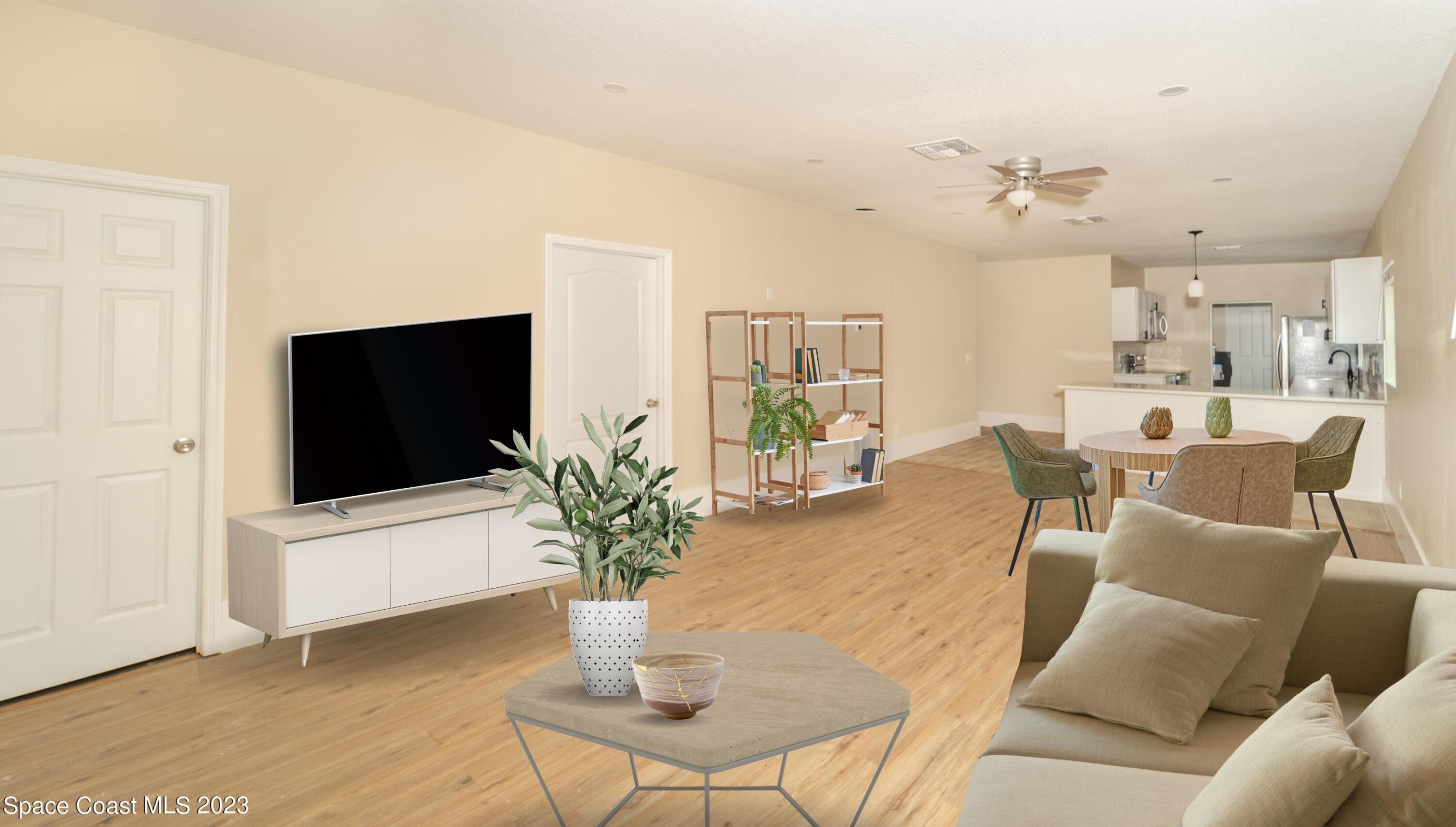 254 Lime Street Cocoa, FL 32926 - Photo 8 of 16 a living room with furniture potted plant and a flat screen tv