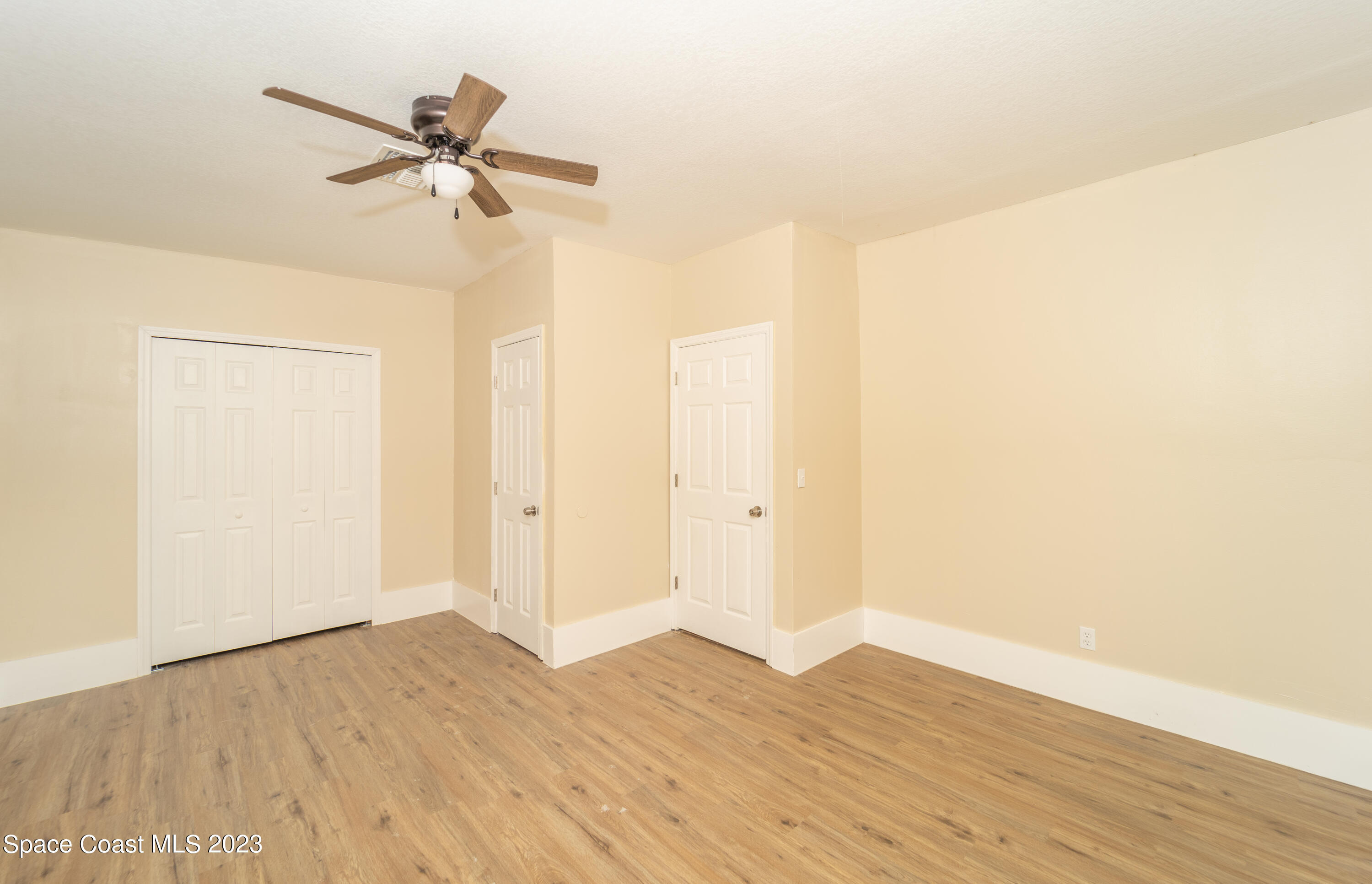 254 Lime Street Cocoa, FL 32926 - Photo 9 of 16 a view of a room with wooden floor and closet