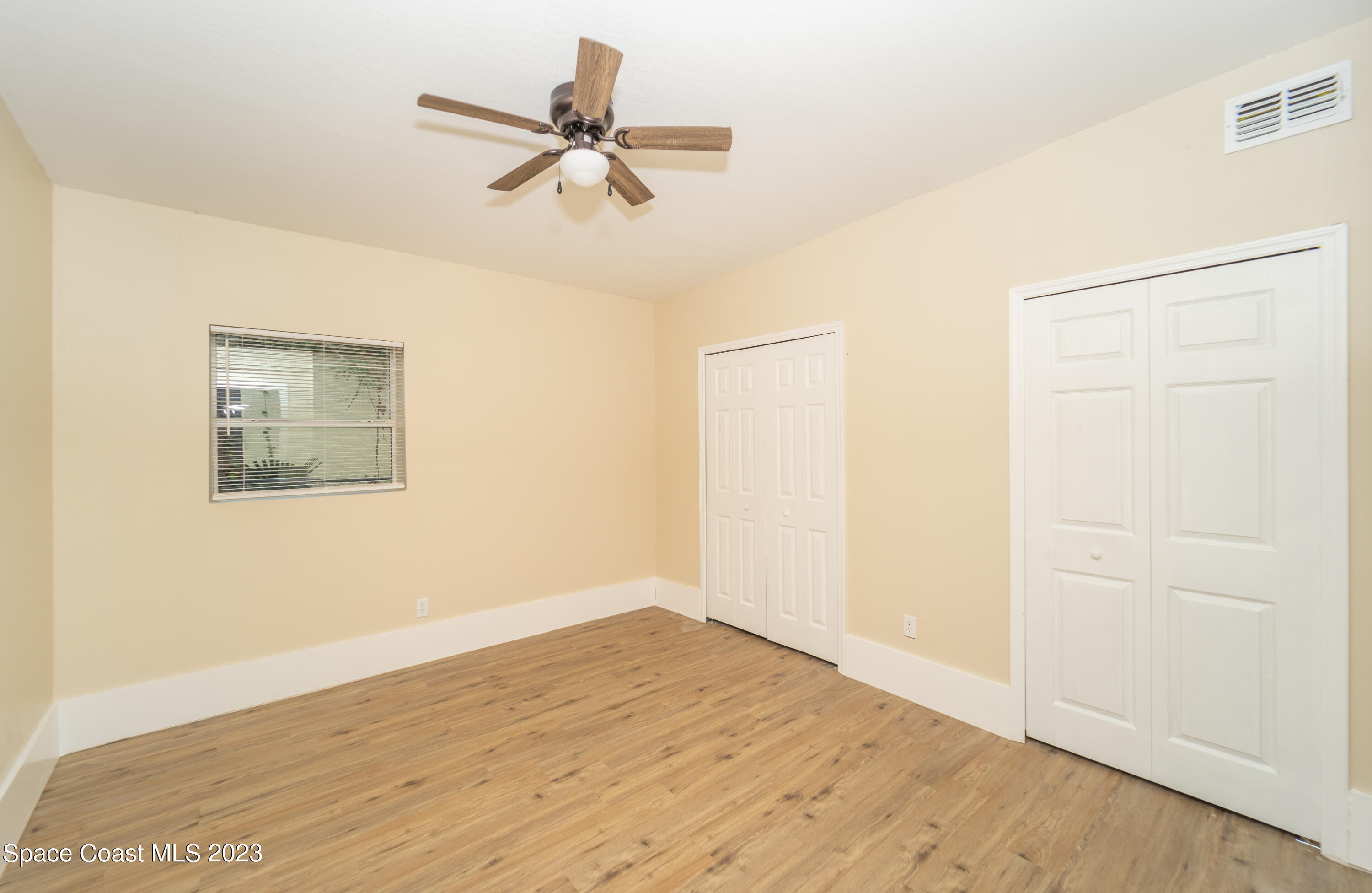254 Lime Street Cocoa, FL 32926 - Photo 10 of 16 a view of a big room with wooden floor closet and windows