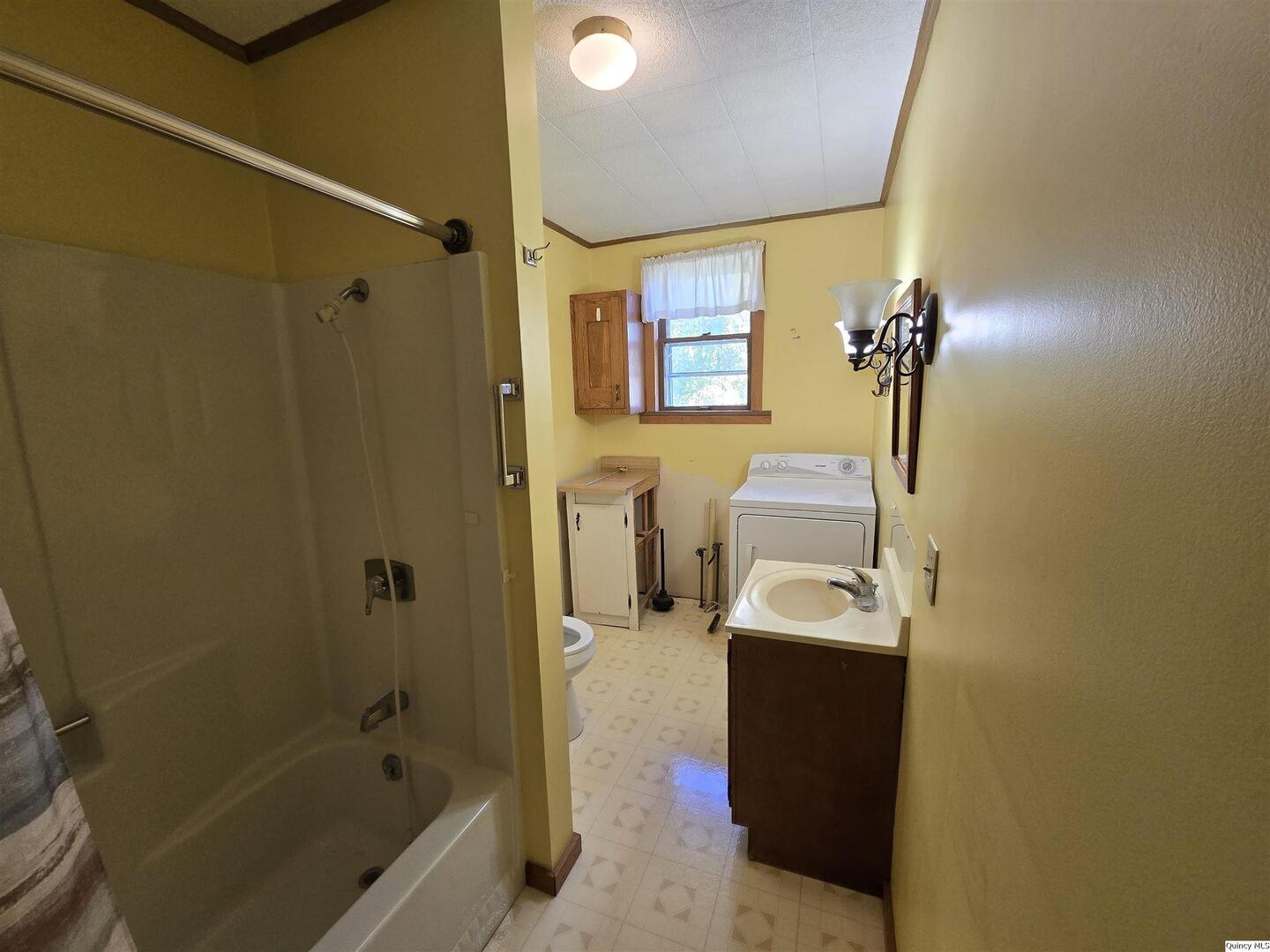 401 Ravenscroft Avenue Versailles, IL 62378 - Photo 11 of 14 a bathroom with a sink a toilet and shower