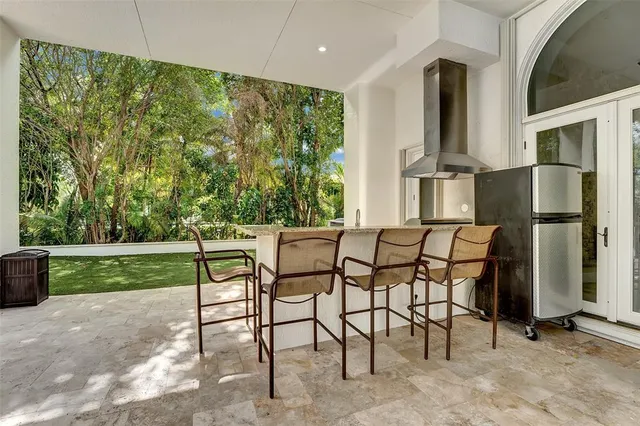 a kitchen with stainless steel appliances kitchen island granite countertop a stove and a sink