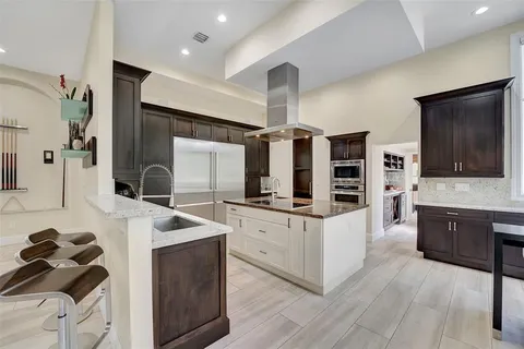 a large kitchen with a table and chairs