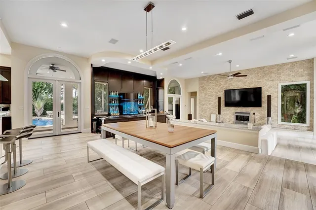 a open kitchen with granite countertop a stove a sink and wooden floor