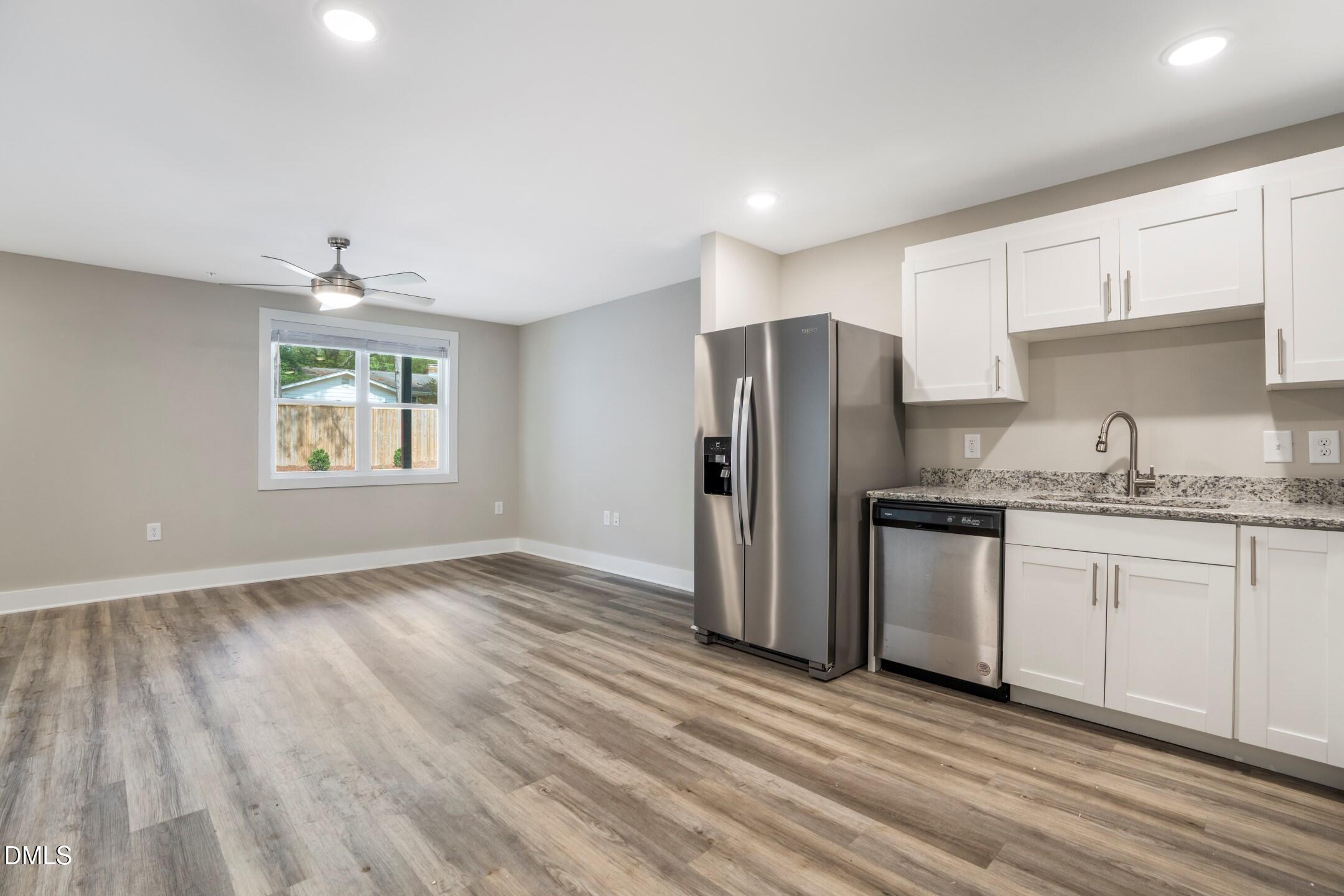 303 Linwood Street, Unit 302 Apex, NC 27502 - Photo 10 of 19 a kitchen with granite countertop a refrigerator and a sink