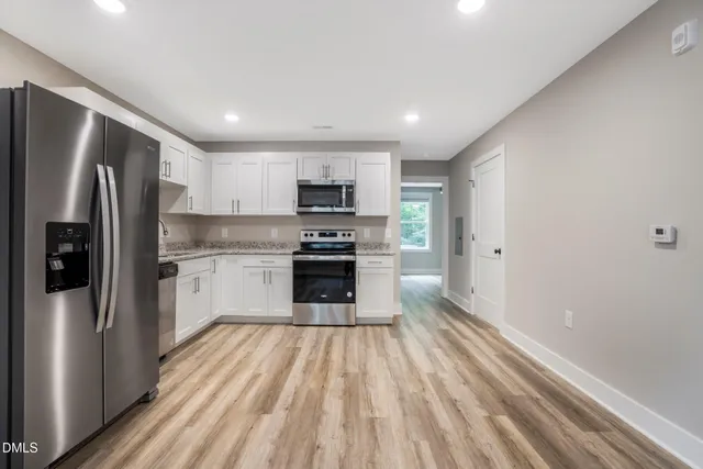 a kitchen with stainless steel appliances a refrigerator sink and stove