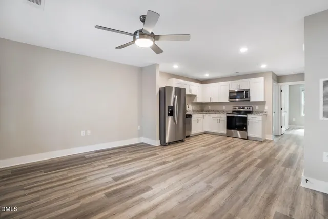 a view of a kitchen with a stove cabinets and wooden floor