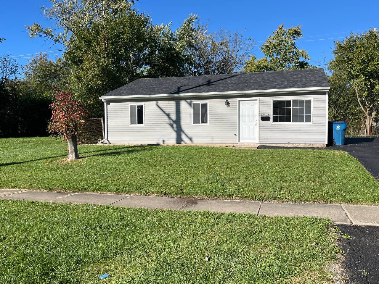 1918 Ashland Avenue Chicago Heights, IL 60411 - Photo 12 of 12 a front view of a house with a yard and trees