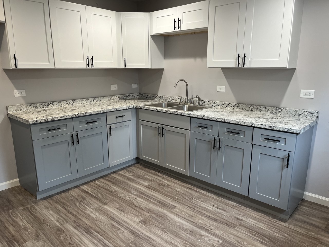 1918 Ashland Avenue Chicago Heights, IL 60411 - Photo 2 of 12 a kitchen with granite countertop a sink cabinets and stainless steel appliances