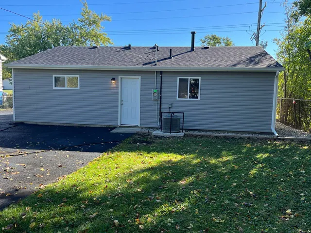 a front view of a house with a garden and yard