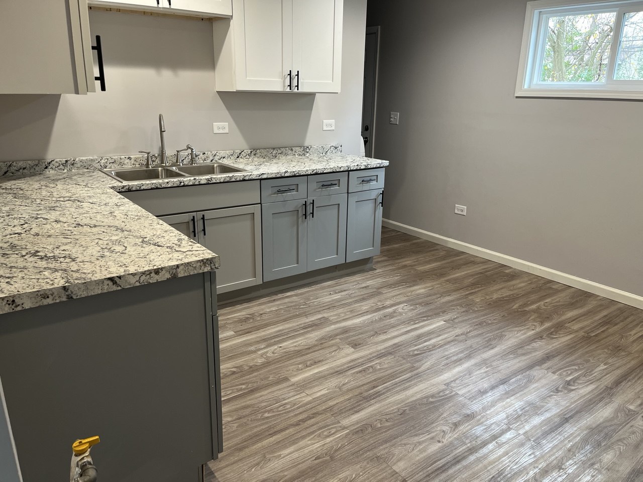 1918 Ashland Avenue Chicago Heights, IL 60411 - Photo 3 of 12 a kitchen with a sink cabinets and wooden floor