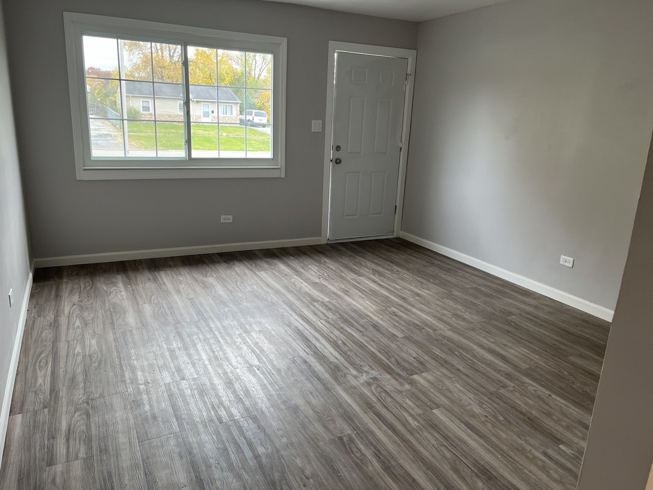 1918 Ashland Avenue Chicago Heights, IL 60411 - Photo 5 of 12 an empty room with wooden floor and windows