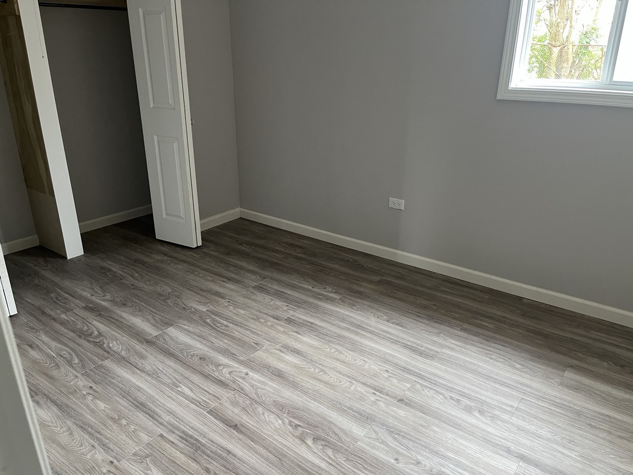 1918 Ashland Avenue Chicago Heights, IL 60411 - Photo 8 of 12 an empty room with wooden floor and window