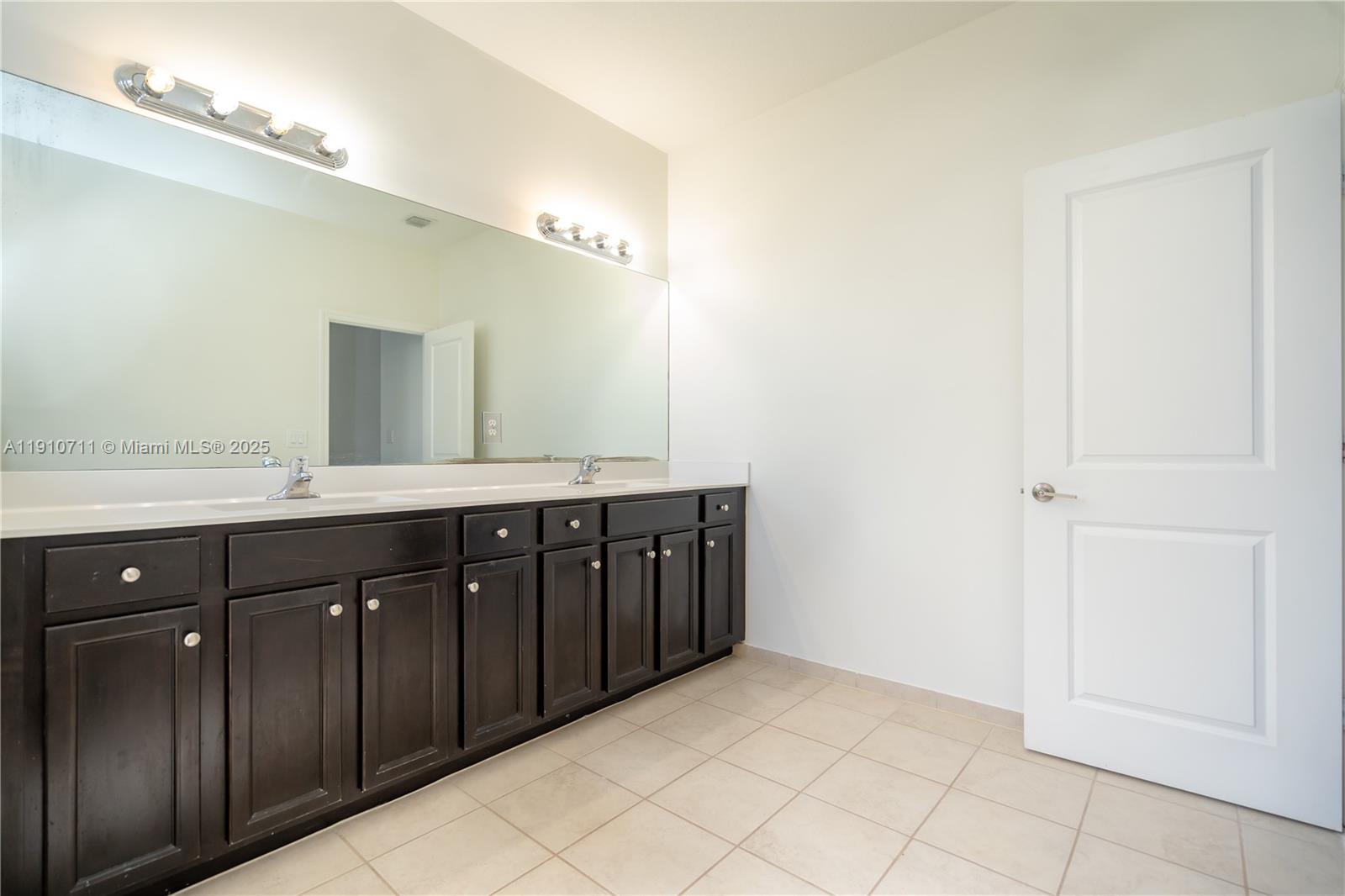 11374 Southwest 254th Terrace Homestead, FL 33032 - Photo 17 of 51 a bathroom with a double vanity sink and a mirror