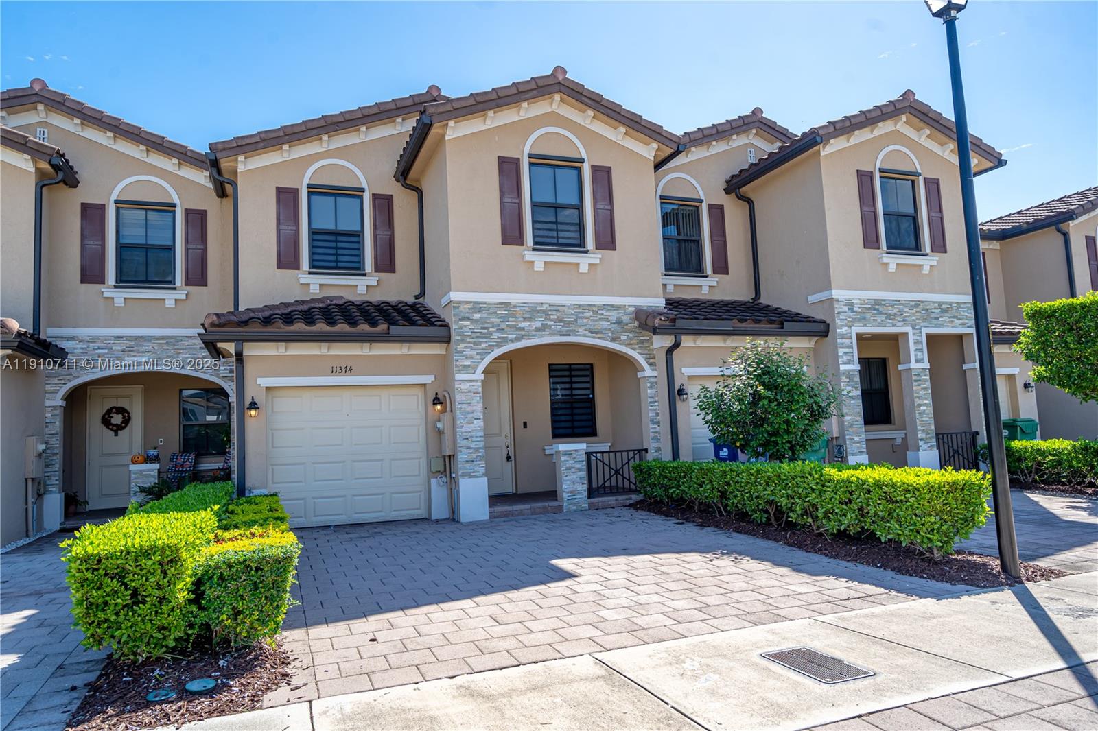 11374 Southwest 254th Terrace Homestead, FL 33032 - Photo 2 of 51 a front view of a house with garden