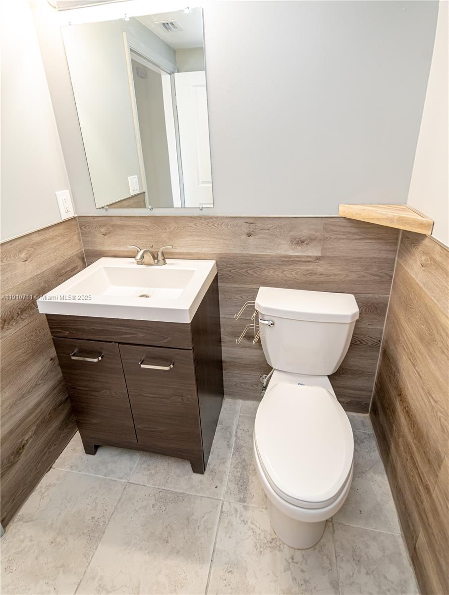 11374 Southwest 254th Terrace Homestead, FL 33032 - Photo 23 of 51 a bathroom with a toilet sink and mirror