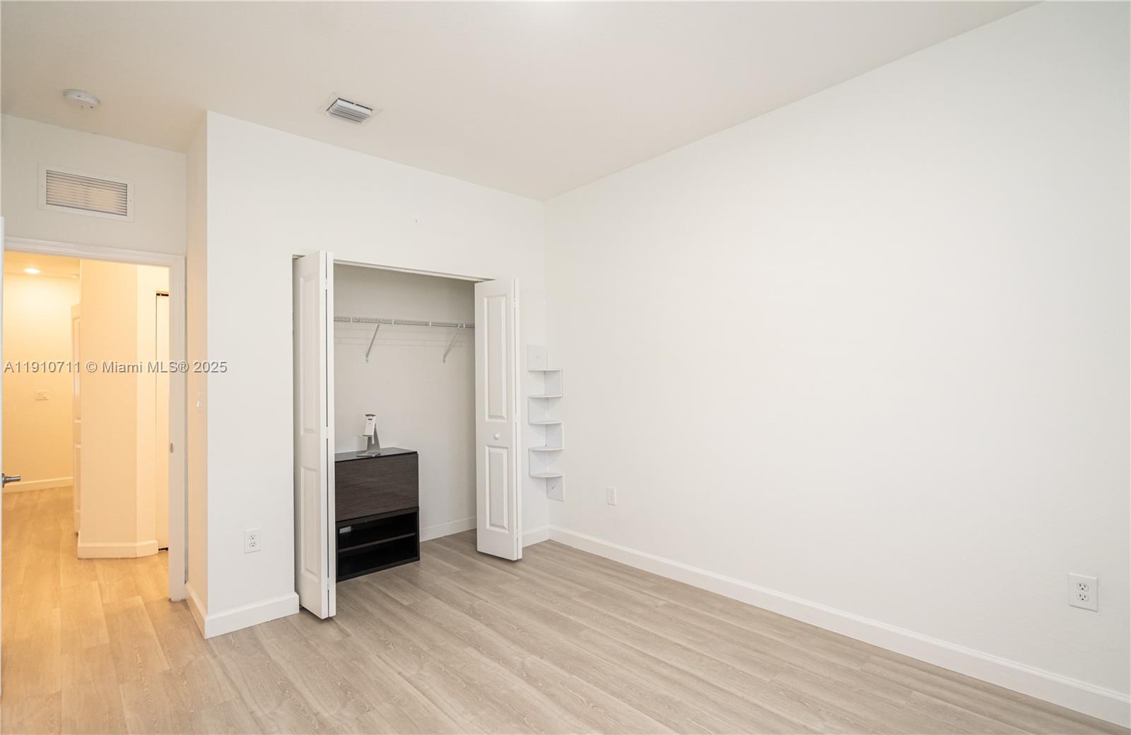 11374 Southwest 254th Terrace Homestead, FL 33032 - Photo 29 of 51 a view of an empty room with wooden floor and a window