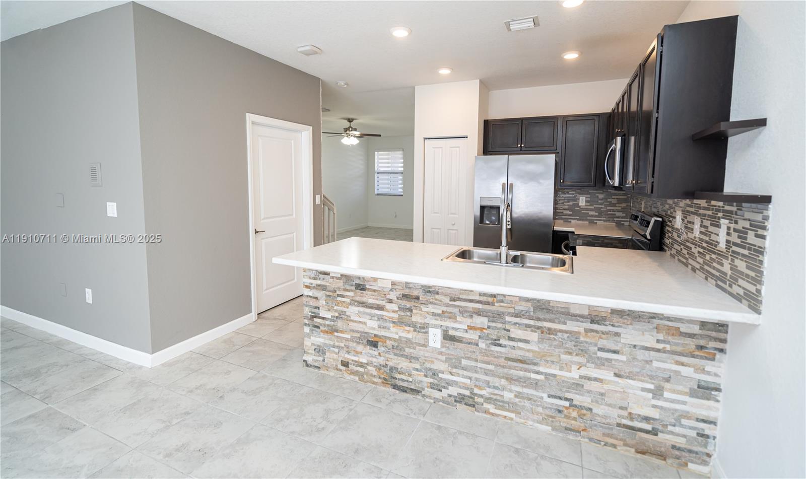 11374 Southwest 254th Terrace Homestead, FL 33032 - Photo 6 of 51 a bathroom with a sink a large mirror and shower