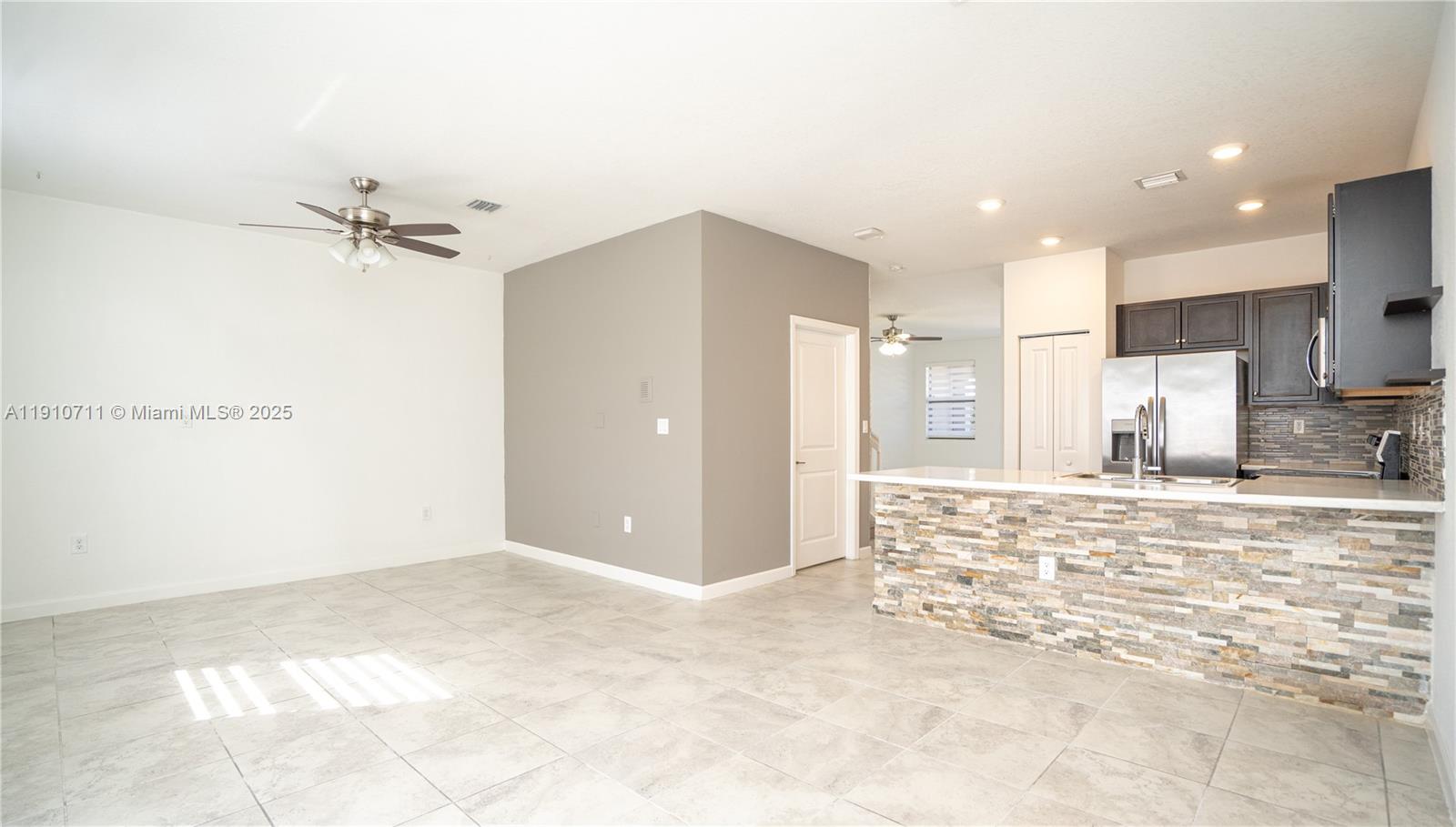 11374 Southwest 254th Terrace Homestead, FL 33032 - Photo 7 of 51 a view of a kitchen with a sink and a refrigerator