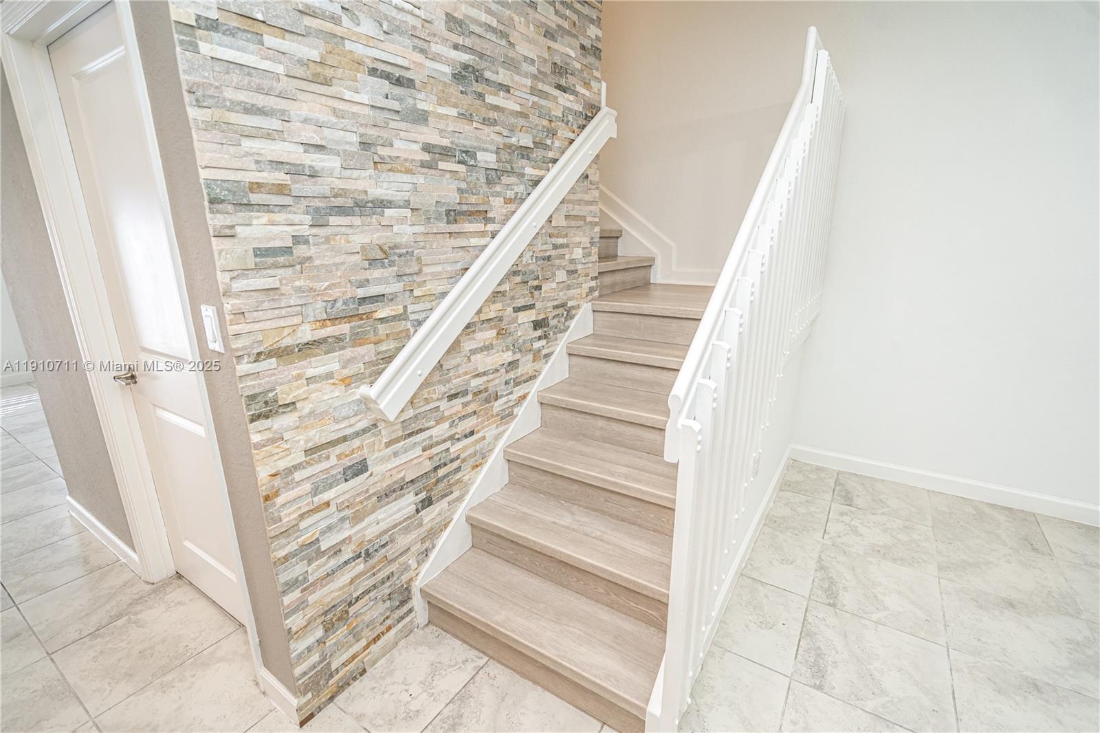 11374 Southwest 254th Terrace Homestead, FL 33032 - Photo 10 of 51 a view of staircase with white walls and white door