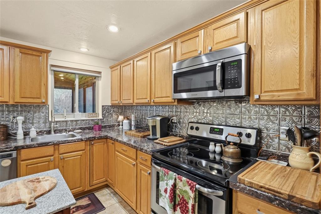 5301 Ranchview Drive Pittsburgh, PA 15236 - Photo 20 of 44 a kitchen with a stove a sink and a microwave