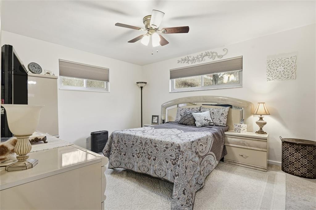 5301 Ranchview Drive Pittsburgh, PA 15236 - Photo 28 of 44 a bedroom with a bed a couch and a chandelier