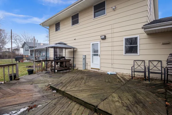 a view of a house with wooden deck