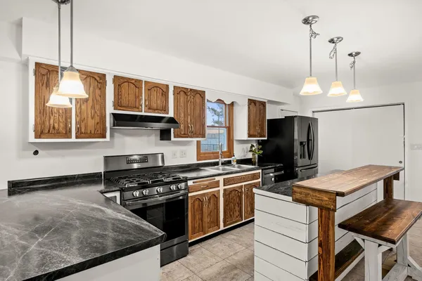 a kitchen with a stove a sink and a refrigerator