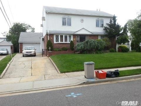 1589 Putney Road Valley Stream, NY 11580 - Photo 1 of 1 a front view of a house with a yard and a street