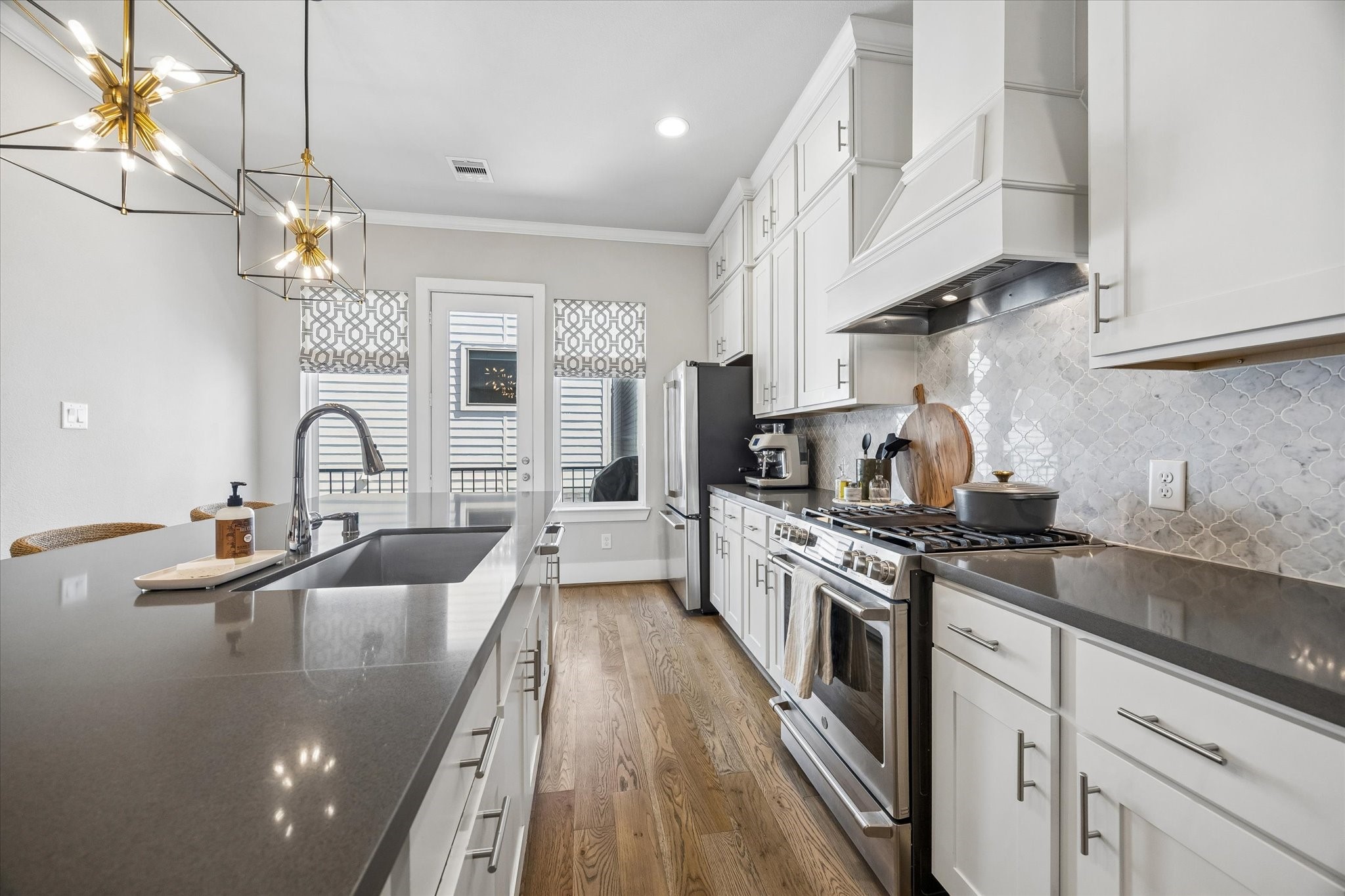 1309 West 24th Street, Unit B Houston, TX 77008 - Photo 11 of 22 Handsome stone countertops in the kitchen with an enormous island, room for many barstools. Imagine entertaining guests as everyone gathers around your kitchen.