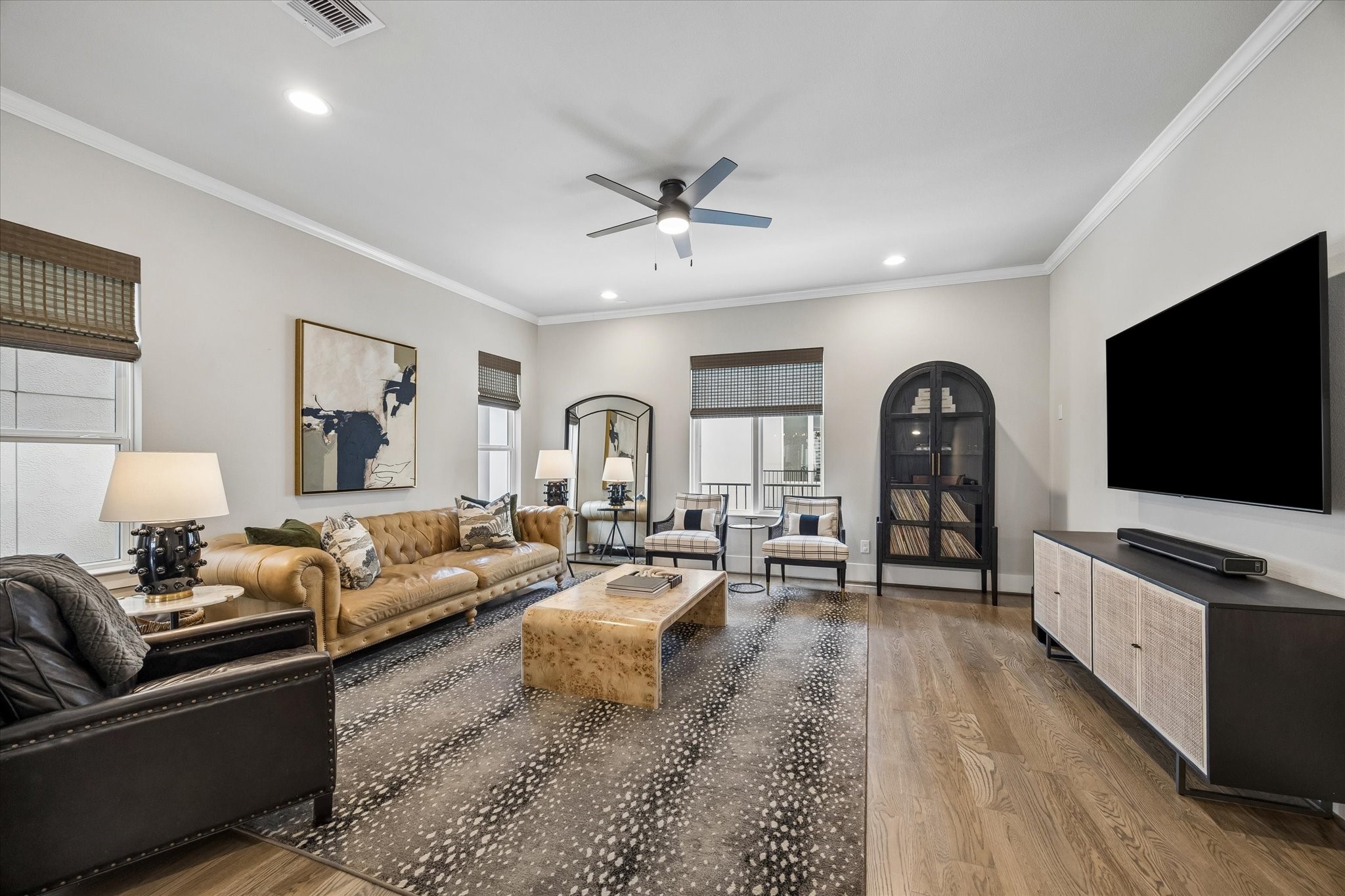 1309 West 24th Street, Unit B Houston, TX 77008 - Photo 5 of 22 Spacious living room measuring 18' x 18' with gleaming hardwood flooring, recessed lighting, crown molding and ceiling fan.