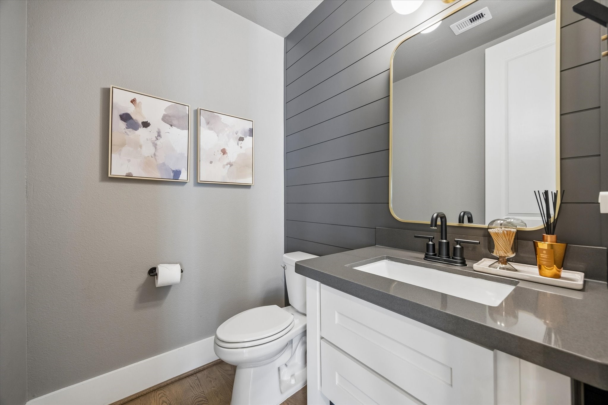 1309 West 24th Street, Unit B Houston, TX 77008 - Photo 9 of 22 Luxurious baths throughout. This is the powder room off the living area, notice the custom millwork accent wall installed by the current owner.