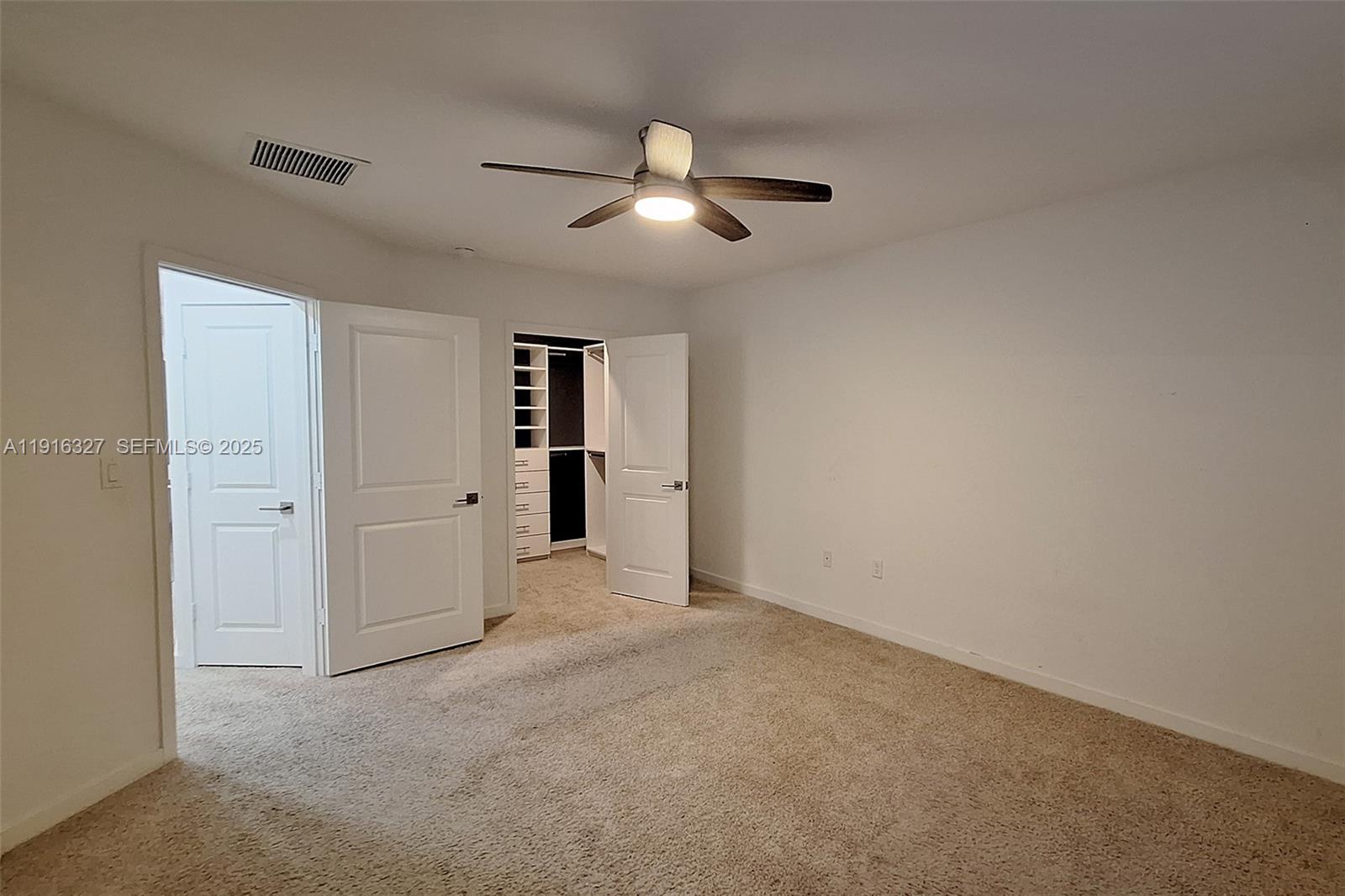 1325 Northwest 208th Street Miami Gardens, FL 33169 - Photo 14 of 38 an empty room with closet and windows