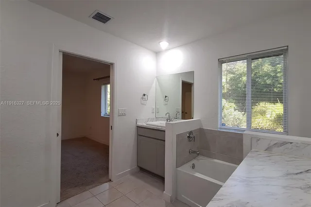 a bathroom with a granite countertop sink a toilet and shower