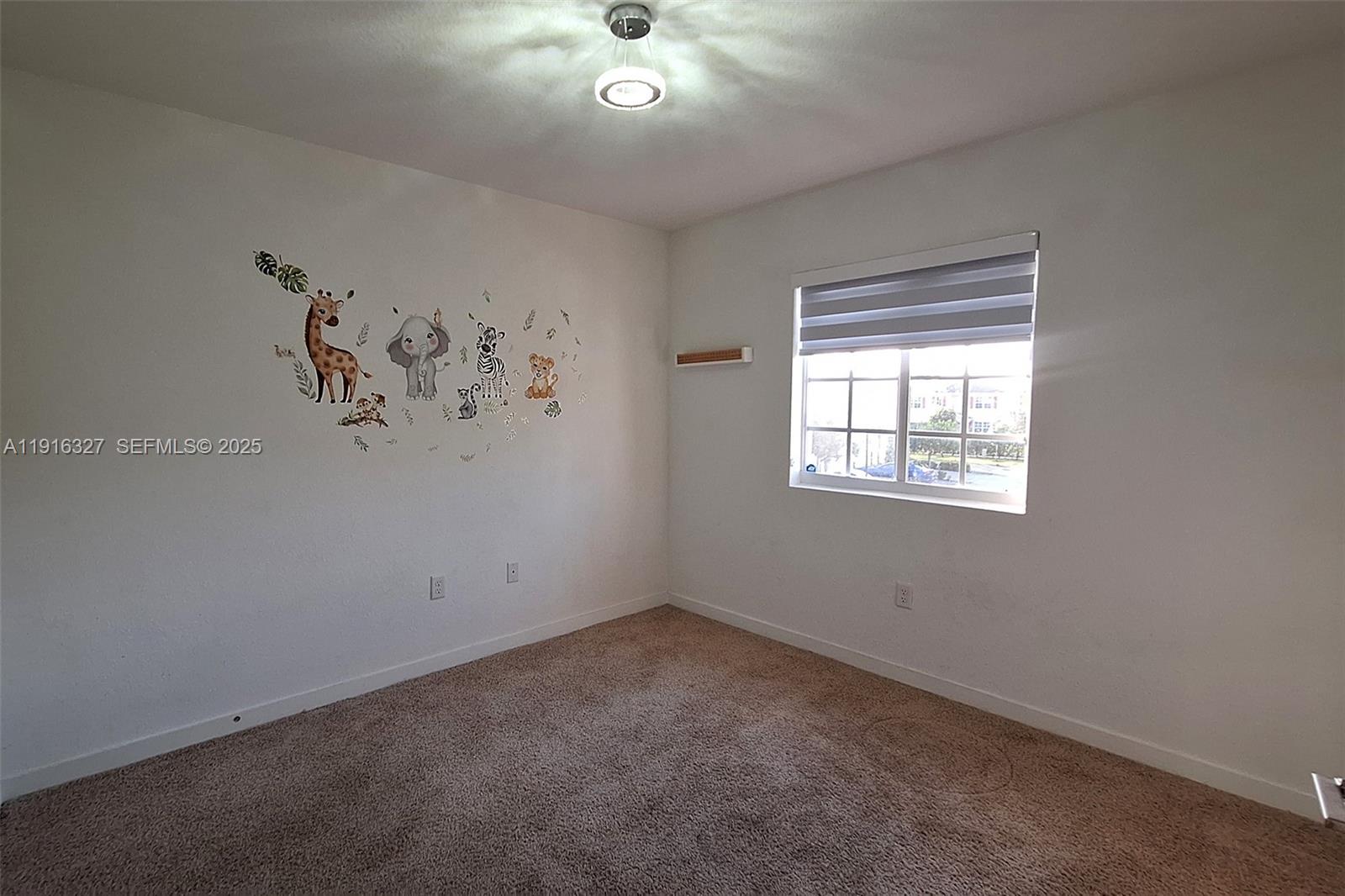1325 Northwest 208th Street Miami Gardens, FL 33169 - Photo 19 of 38 an empty room with a window