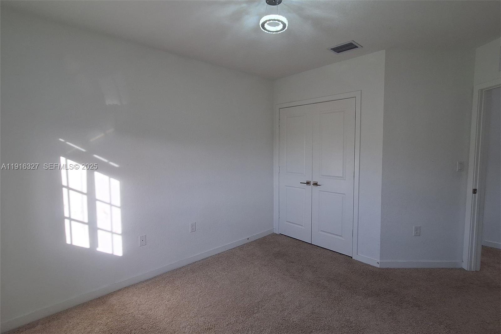 1325 Northwest 208th Street Miami Gardens, FL 33169 - Photo 25 of 38 an empty room with windows