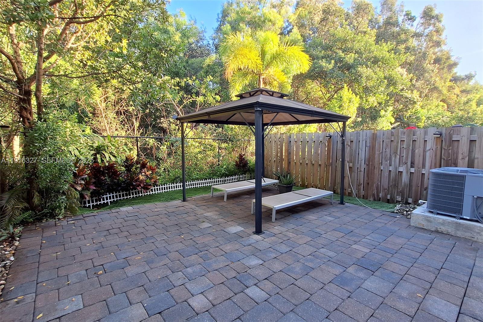 1325 Northwest 208th Street Miami Gardens, FL 33169 - Photo 30 of 38 a view of a bench in a backyard