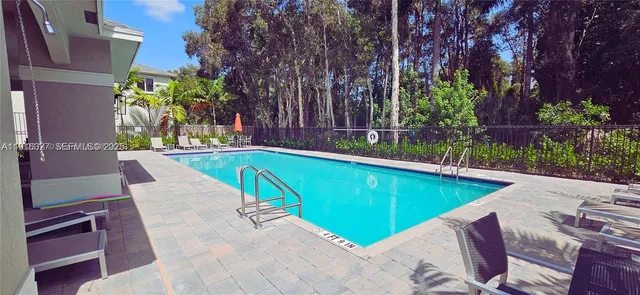 a front view of a house with a yard and potted plants