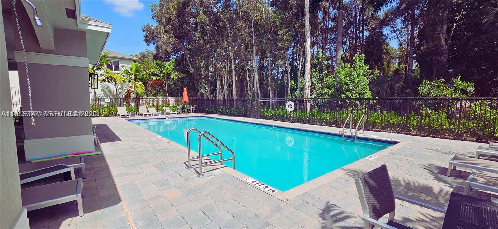 1325 Northwest 208th Street Miami Gardens, FL 33169 - Photo 34 of 38 a view of a swimming pool with a patio