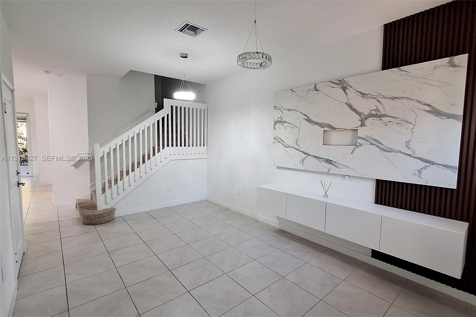 1325 Northwest 208th Street Miami Gardens, FL 33169 - Photo 4 of 38 a view of a livingroom with a staircase