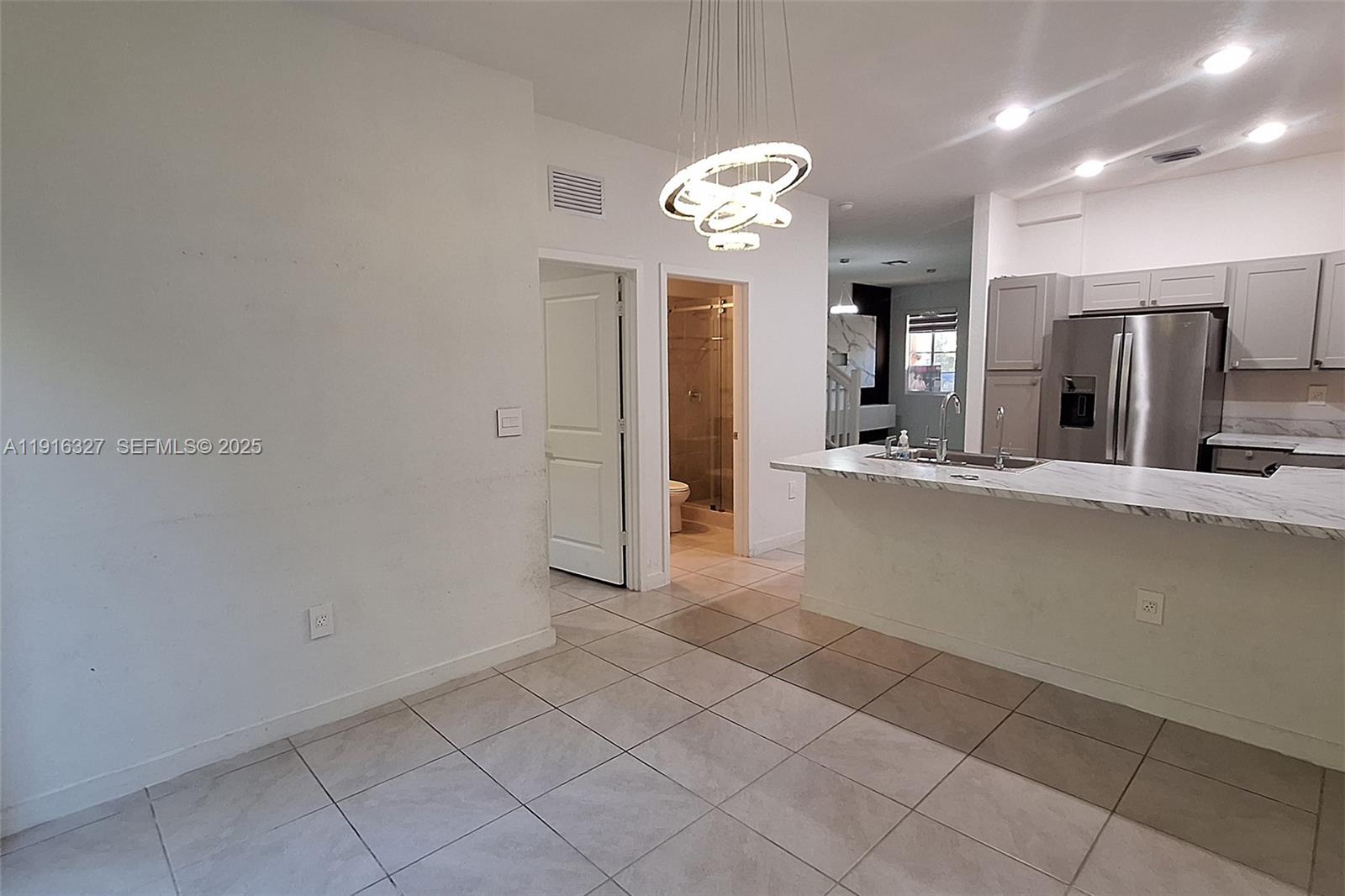 1325 Northwest 208th Street Miami Gardens, FL 33169 - Photo 7 of 38 a large kitchen with cabinets and stainless steel appliances