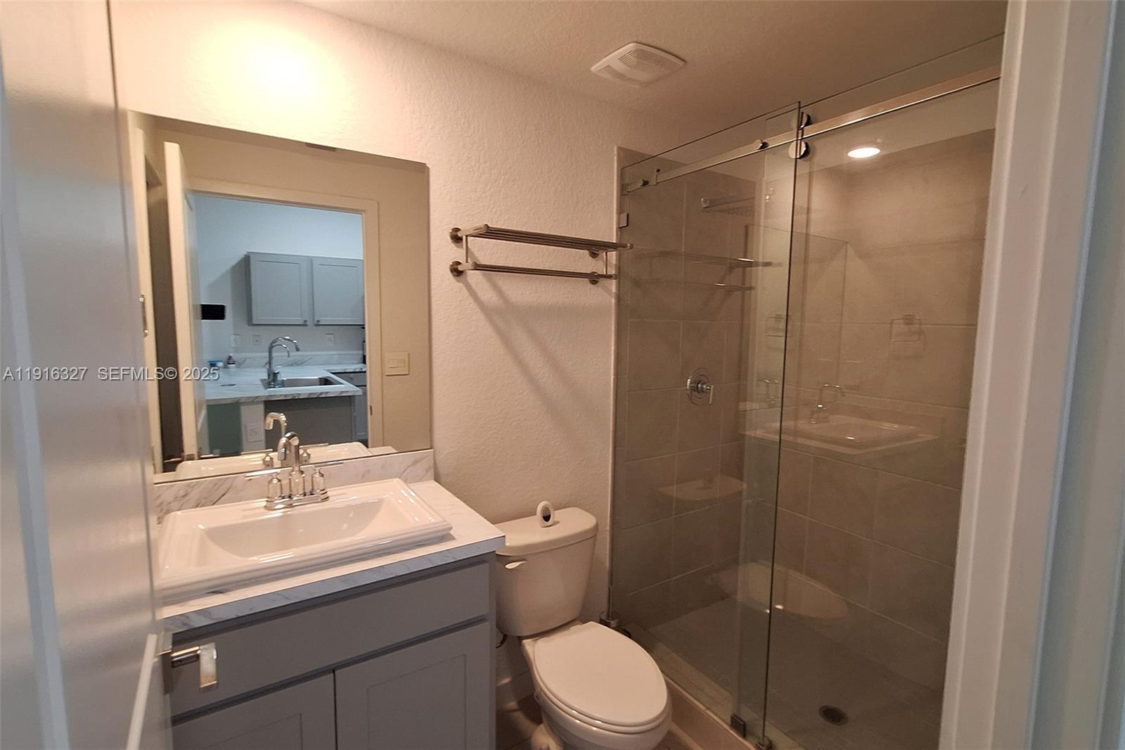 1325 Northwest 208th Street Miami Gardens, FL 33169 - Photo 10 of 38 a bathroom with a sink a toilet and shower