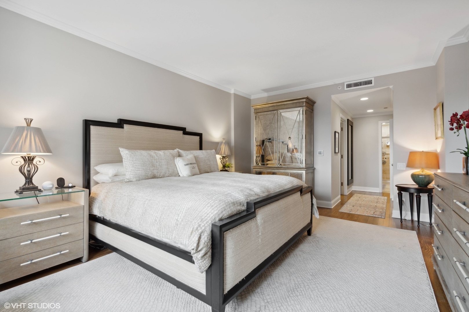 1301 North Dearborn Street, Unit 705 Chicago, IL 60610 - Photo 13 of 25 a bedroom with a bed and a mirror on dresser